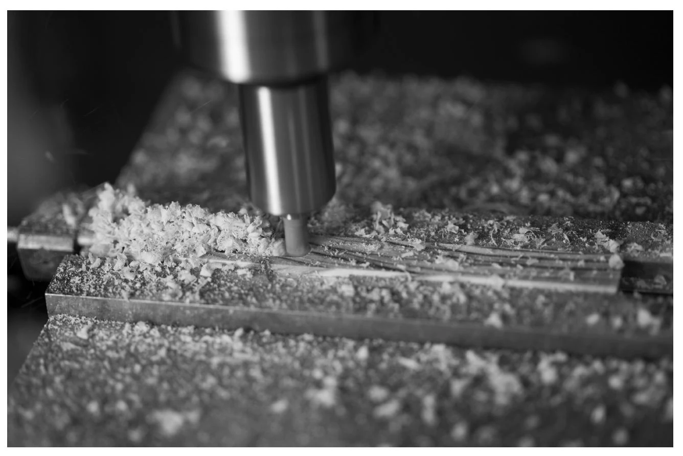 A milling cutter rough-machining the Cocobolo wood for a PRO3X grip.