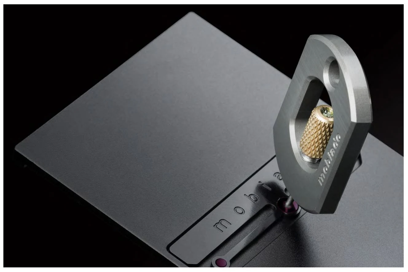 The PRO3X opening key inserted beside ruby contact inserts in the battery-cover mechanism.