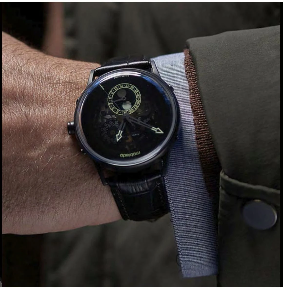 A Zaffiro skeleton wristwatch with a blue case, worn on the wrist.