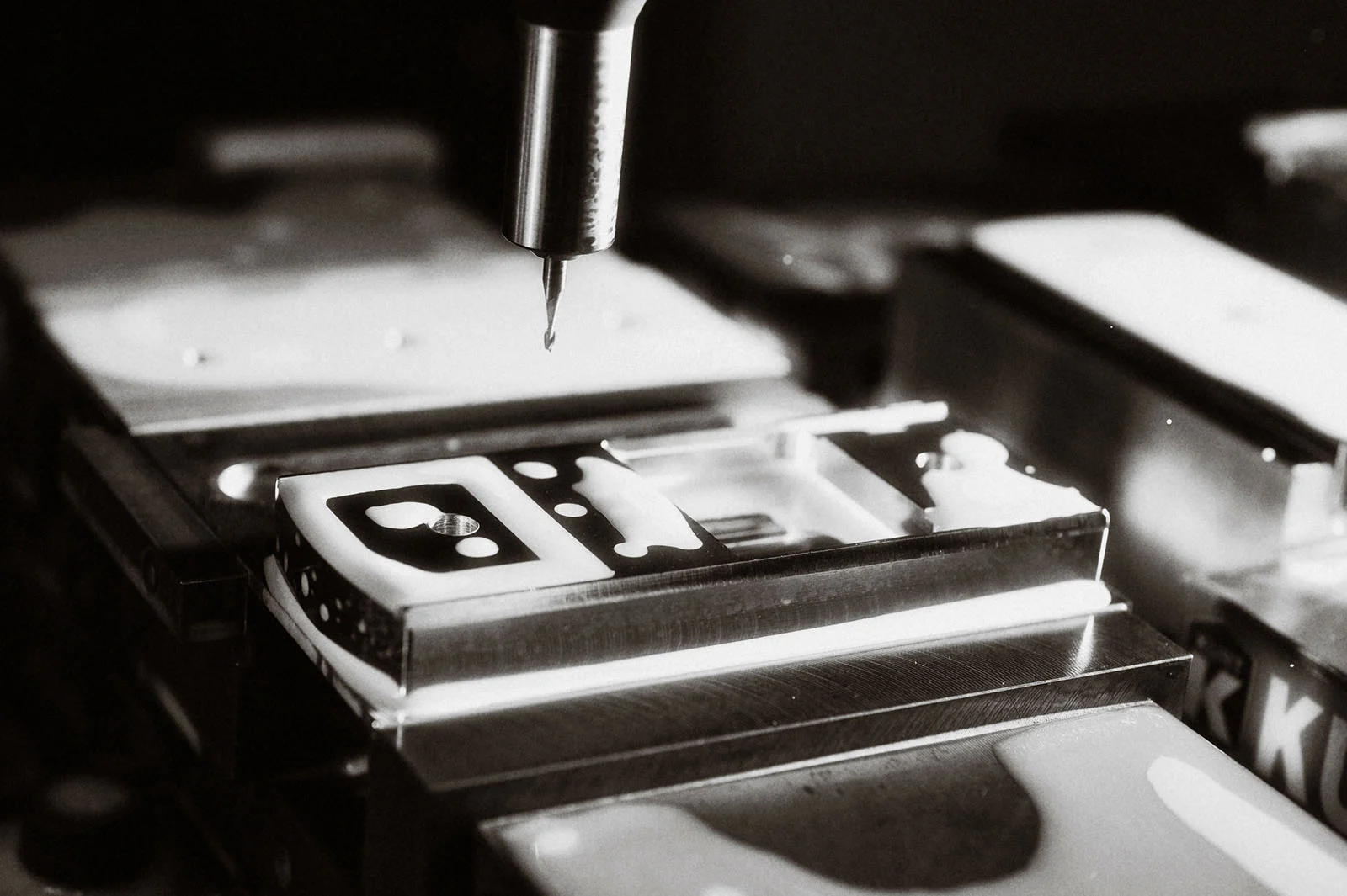 Machining a Mobiado phone body in an original workshop photograph.